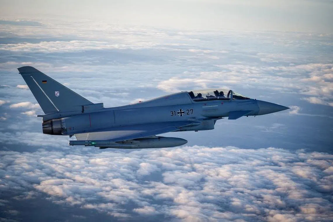 FILE PHOTO: A Eurofighter jet accompanies the flight of German Chancellor Olaf Scholz in an Airbus A400M airforce transport aircraft, on his way to visit the Cologne-Bonn Air Force base, to attend a demonstration of the capabilities of the Territorial Command of the German army Bundeswehr in Wahn a suburb of Cologne, Germany, October 23, 2023.  Kay Nietfeld/Pool via REUTERS/File Photo