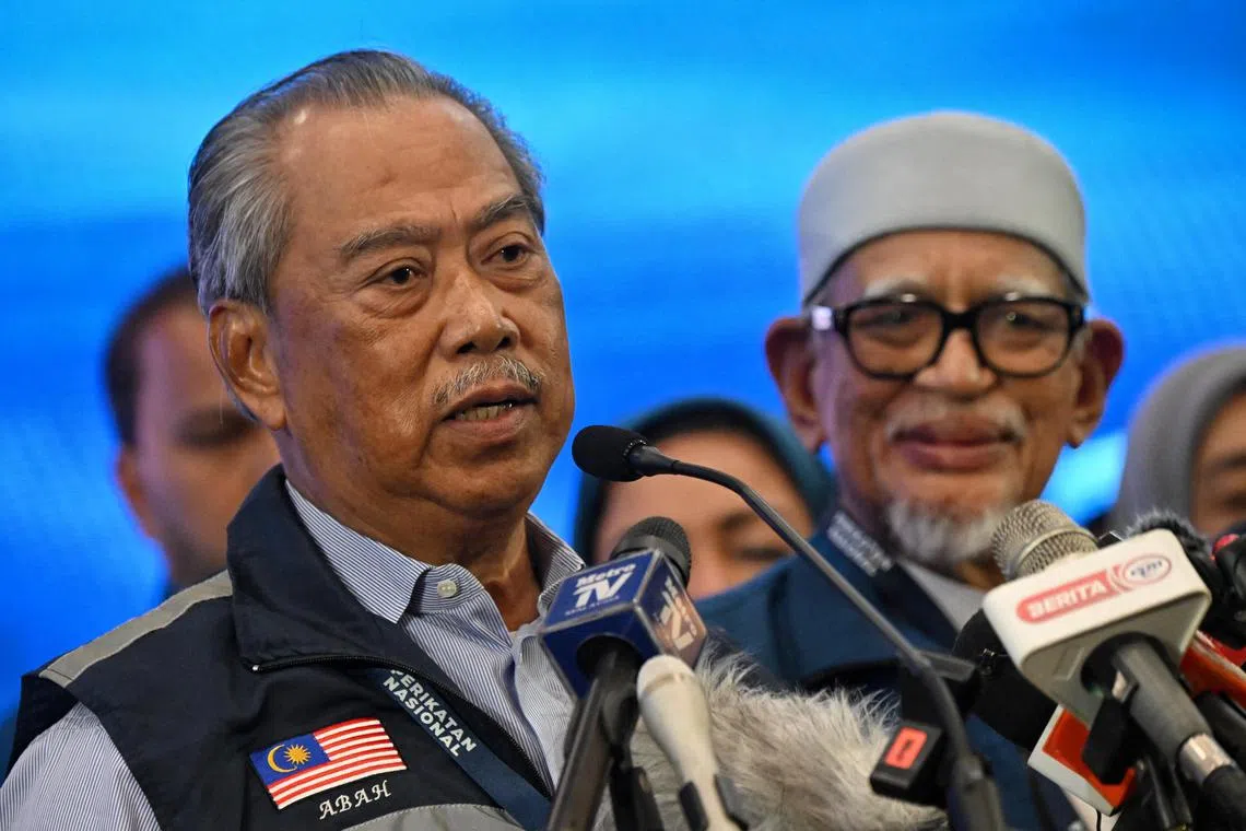 Perikatan Nasional chairman Muhyiddin Yassin (left) delivering a speech alongside PAS president Abdul Hadi Awang at the Glenmarie Golf And Country Club in KL on Nov 19, 2022.