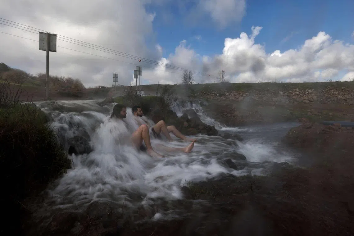 Israelis bath in a hot spring during the winter season, near the settlement of Merom Golan in the Israeli-annexed Golan Heights, on January 17, 2023. 
