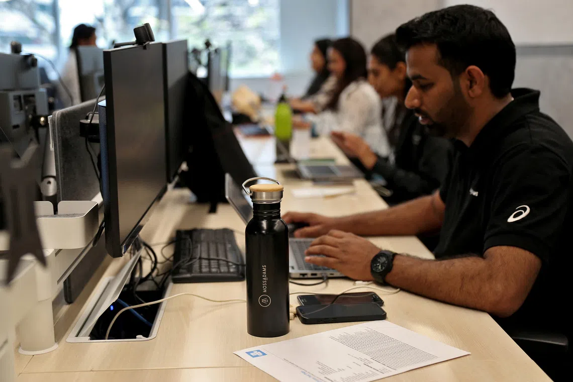 Employees work inside the office of Moss Adams, a U.S. accounting firm, in Bengaluru, India, April 23, 2025. REUTERS/Stringer