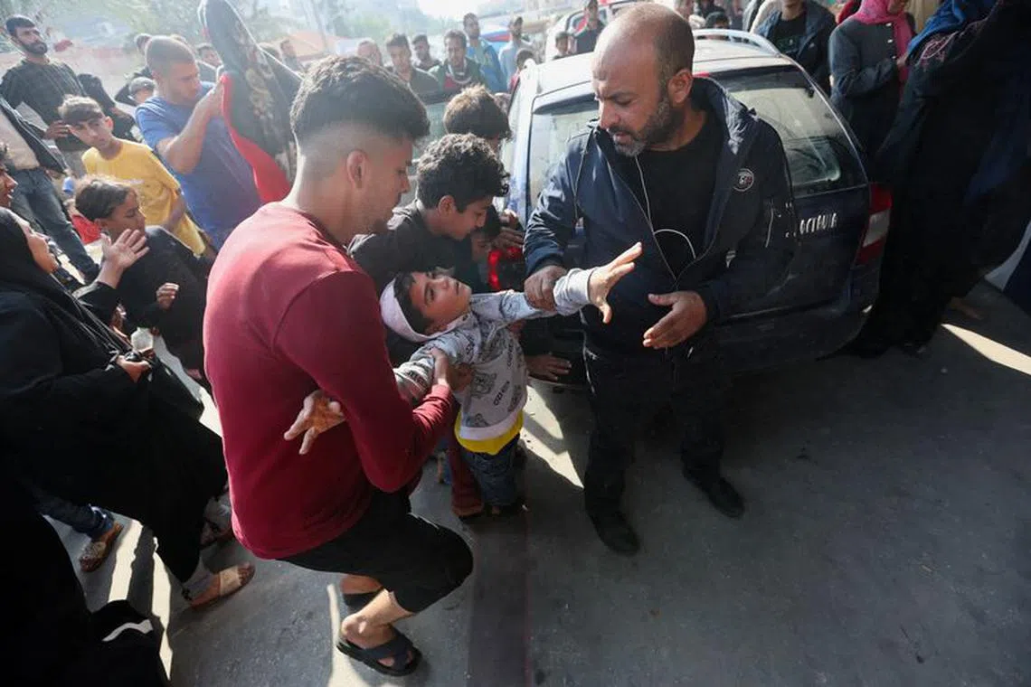 A Palestinian boy is rushed into hospital following an Israeli strike, after a temporary truce between Hamas and Israel expired, at Nasser hospital in Khan Younis in the southern Gaza Strip, December 1, 2023. REUTERS/Ibraheem Abu Mustafa