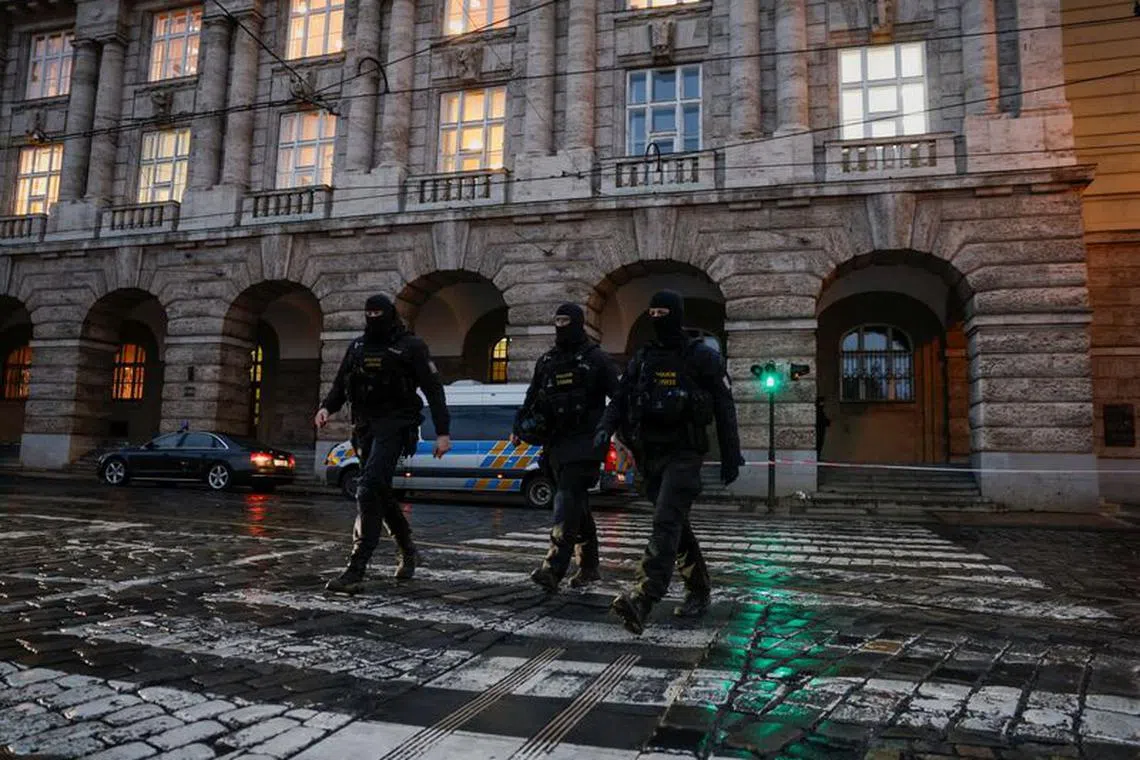 Members of the Police walk on the road following a shooting at one of Charles University's buildings in Prague, Czech Republic, December 22, 2023. REUTERS/David W Cerny