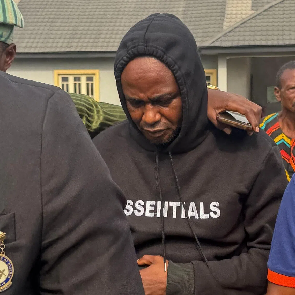 Adeniyi Mobolaji Kayode (C), the driver charged in the car crash that injured Anthony Joshua and killed his friends, walks at a court in Sagamu on January 20, 2026. Adeniyi Mobolaji Kayode, 46, was driving the former two-time heavyweight champion Joshua and two of his friends, Latif Ayodele and Sina Ghami when their Lexus SUV rammed into a stationary truck.
Kayode faces multiple reckless driving charges as well as a charge of driving without a license. (Photo by Tonye BAKARE / AFP)