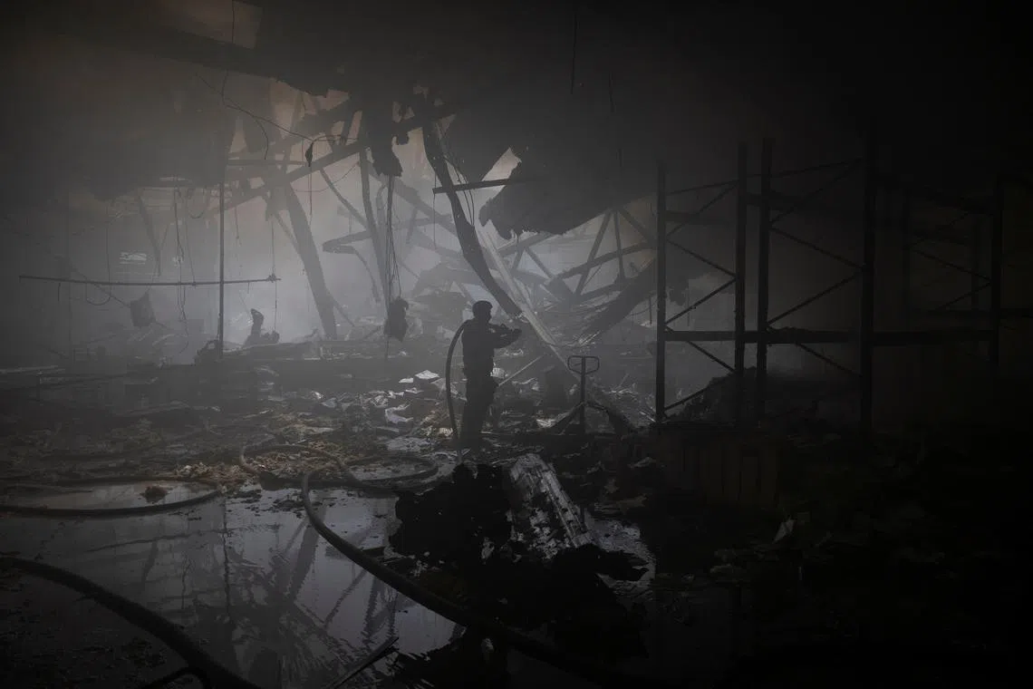 A firefighter works at the site where a printworks was hit by Russian missile strikes, amid Russia's attack on Ukraine, in Kharkiv, Ukraine May 23, 2024. REUTERS/Valentyn Ogirenko/ File Photo