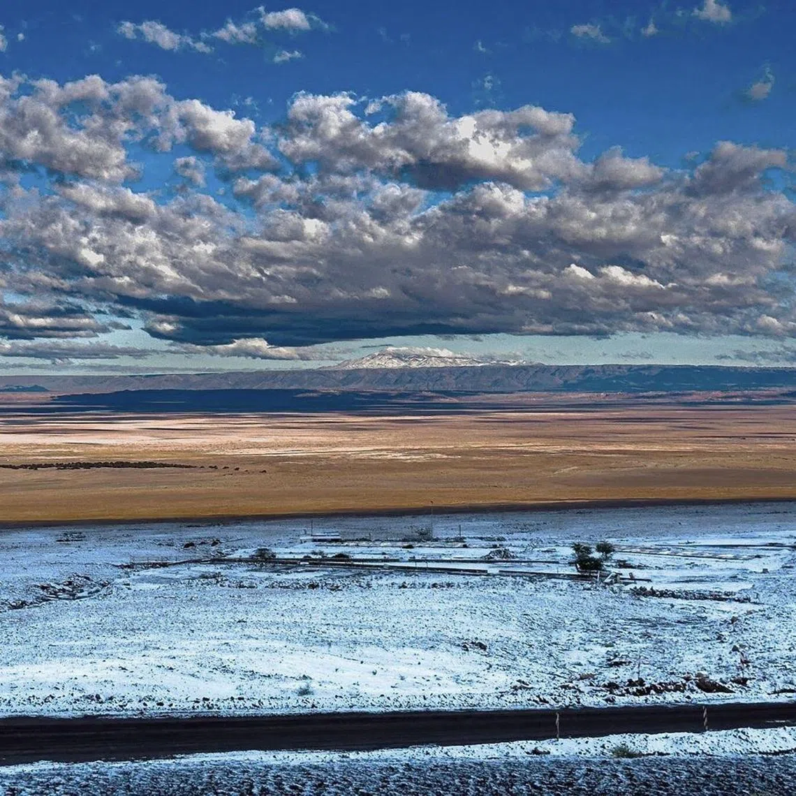 This handout picture released by the Alma Observatory in the Atacama Desert shows snowfall at dawn, a phenomenon that had not occurred in 10 years, in Atacama, northern Chile, on June 26, 2025. 