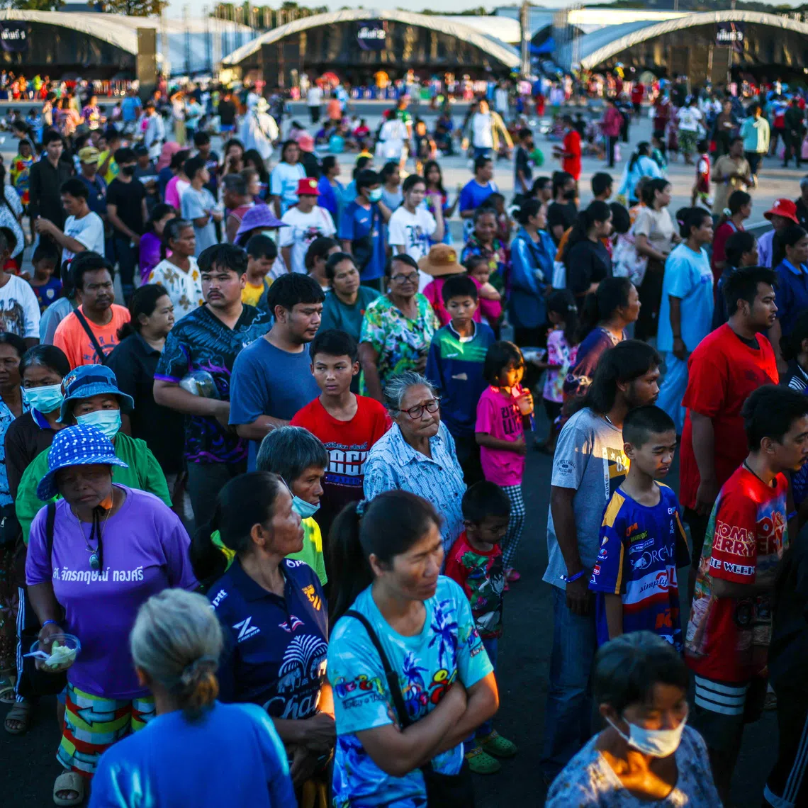 Displaced people queue for food at a temporary shelter amid clashes between Thailand and Cambodia along a disputed border area, in Buriram province, Thailand, December 16, 2025. REUTERS/Athit Perawongmetha