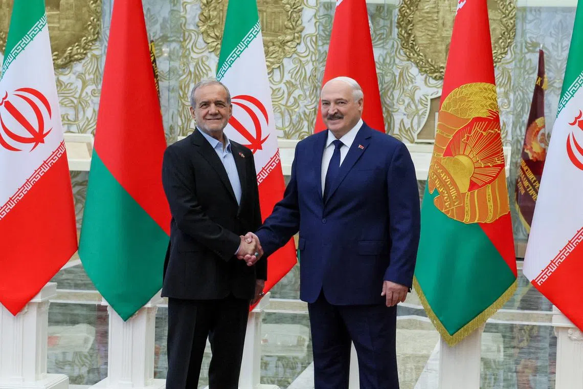 Belarusian President Alexander Lukashenko and Iranian President Masoud Pezeshkian shake hands during a meeting in Minsk, Belarus, August 20, 2025. Press Service of the President of the Republic of Belarus/Handout via REUTERS