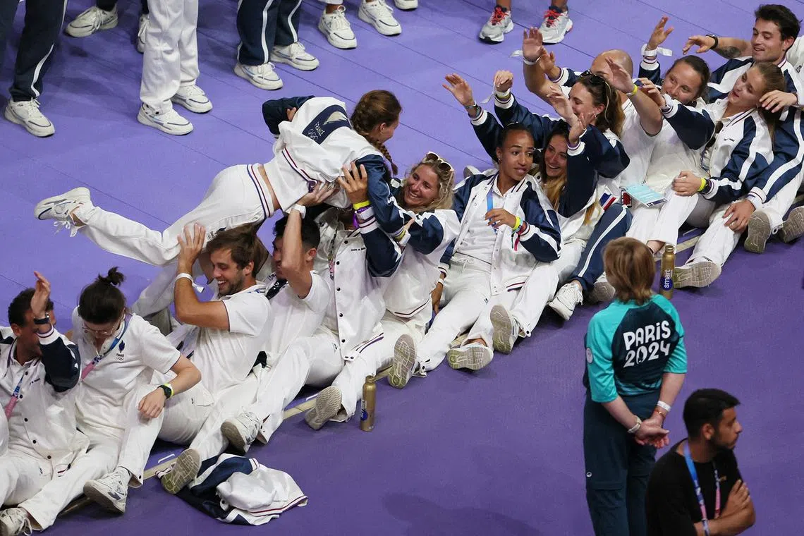 French athletes enjoying a playful moment at the closing ceremony of the Paris Olympics at the Stade de France on Aug 11, 2024.