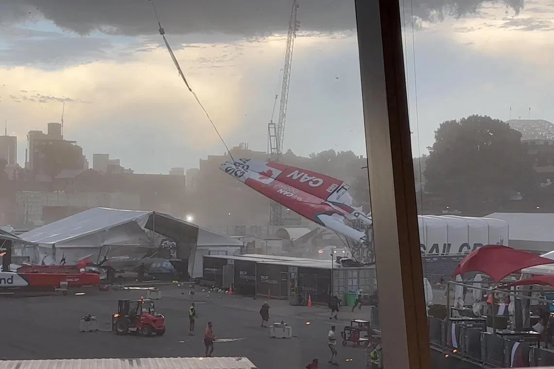 Canadian wing sail attached to a mechanical crane is blown into a marquee and crashed to the ground during heavy windy conditions during the Australia Sail Grand Prix in Sydney Harbour, Australia Feb 18, 2023.