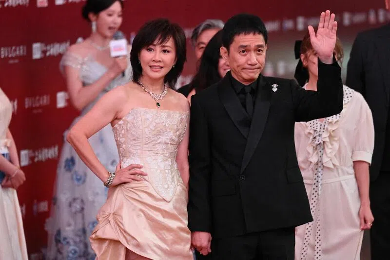 Hong Kong actress Carina Lau Ka Ling and Hong Kong actor Tony Leung Chiu Wai (right) arrive on the red carpet of the 28th Shanghai International Film Festival in Shanghai, on June 13.