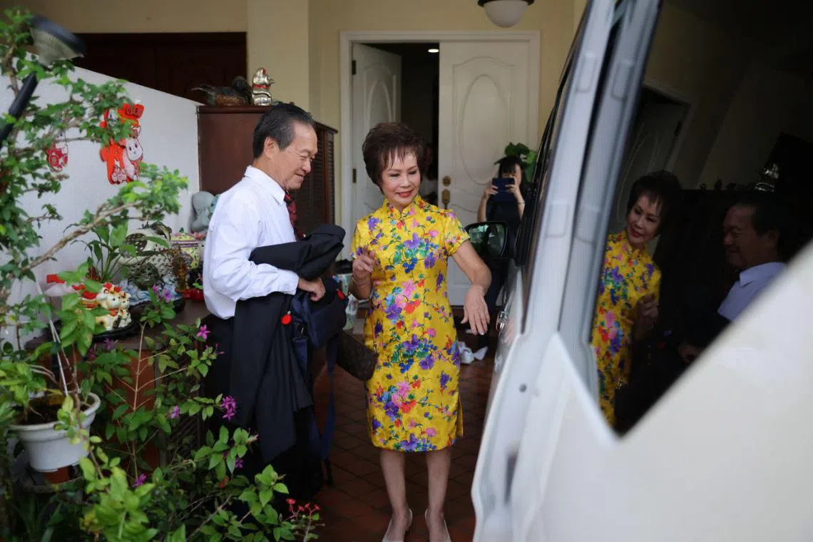 Tan Kin Lian and his wife leaving their home for the Nomination Centre.