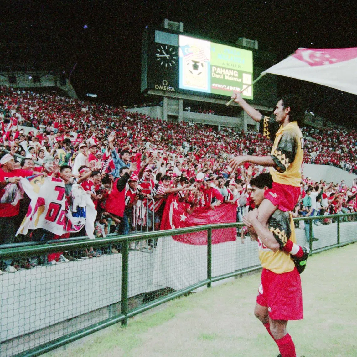 Kadir Yahaya carries vice-captain Malek Awab after Singapore beat Pahang in Malaysia Cup final on Dec 17, 1994.