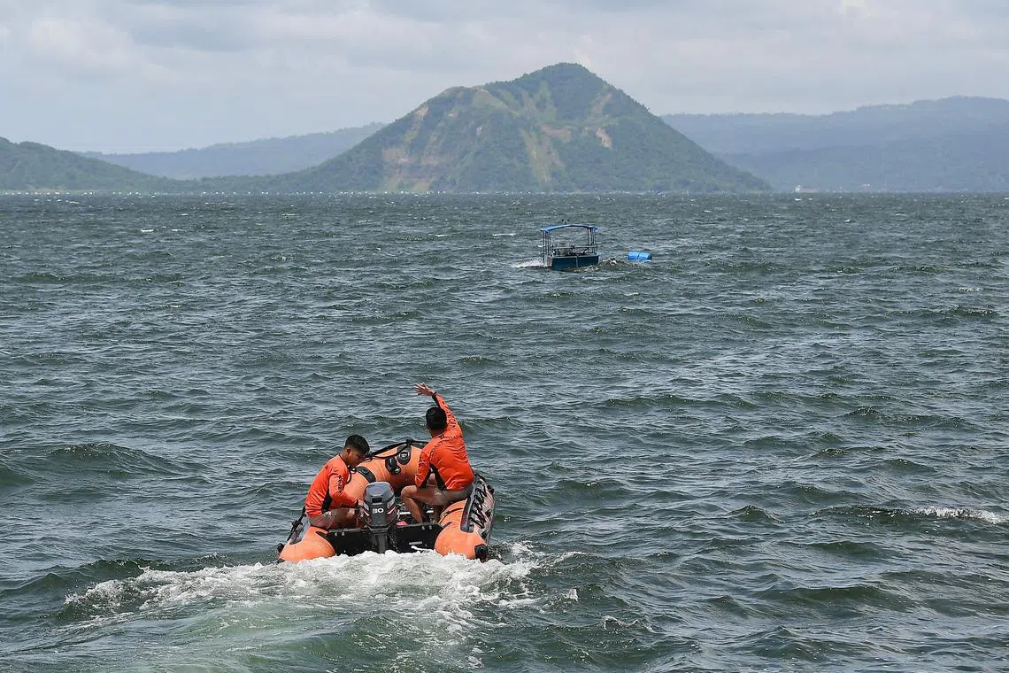 Philippine coast guard personnel prepare to depart to the site where the bodies of cockfighters were allegedly dumped, in Lake Taal off Talisay town, Batangas province, South of Manila on July 10, 2025. Search teams arrived on July 10 at a lake south of the Philippine capital Manila to look for dozens of cockfighters allegedly murdered by rogue police, the Department of Justice said. (Photo by Ted ALJIBE / AFP)