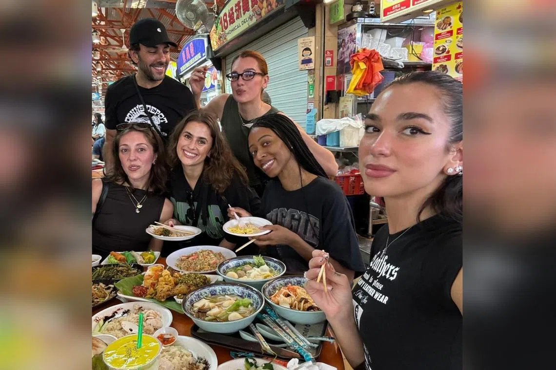 Dua Lipa (right) shares a photo of herself and her crew at a hawker centre on social media on Nov 6.