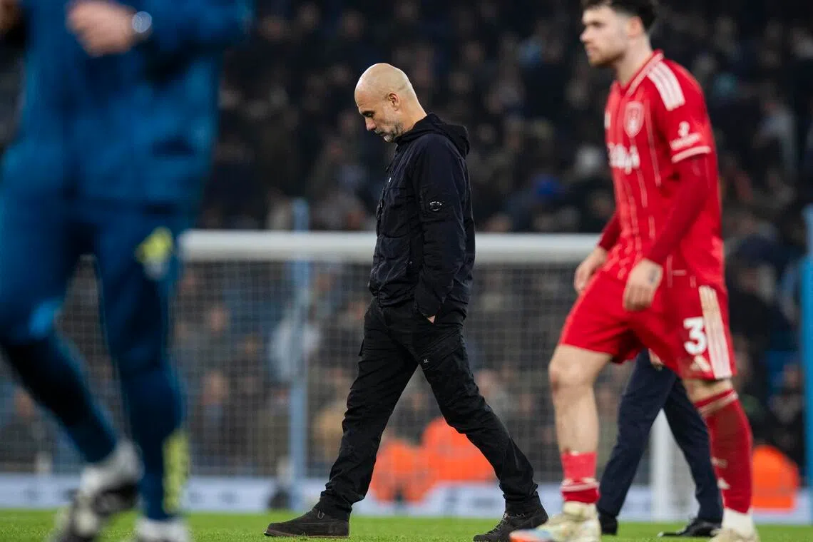 Manchester City manager Pep Guardiola walk on the pitch after the 2-2 Premier League draw with Nottingham Forest.