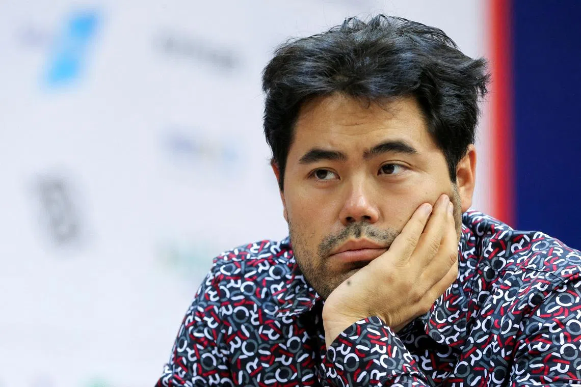 FILE PHOTO: Chess - FIDE World Rapid and Blitz Championships 2022 - Blitz Open - Almaty, Kazakhstan - December 30, 2022. Hikaru Nakamura of the U.S. sits in front of a chess board during a game. REUTERS/Pavel Mikheyev/File Photo