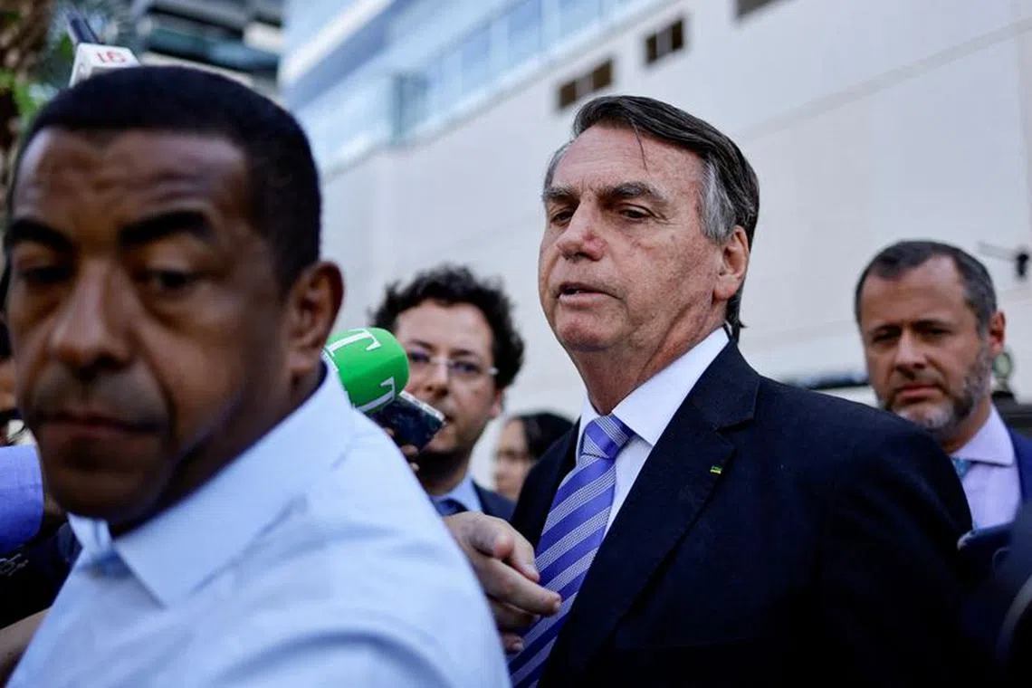 Former Brazilian President Jair Bolsonaro speaks with the media as he leaves the Federal Police headquarters after testifying about the January 8 riots, in Brasilia, Brazil, October 18, 2023. REUTERS/Ueslei Marcelino
