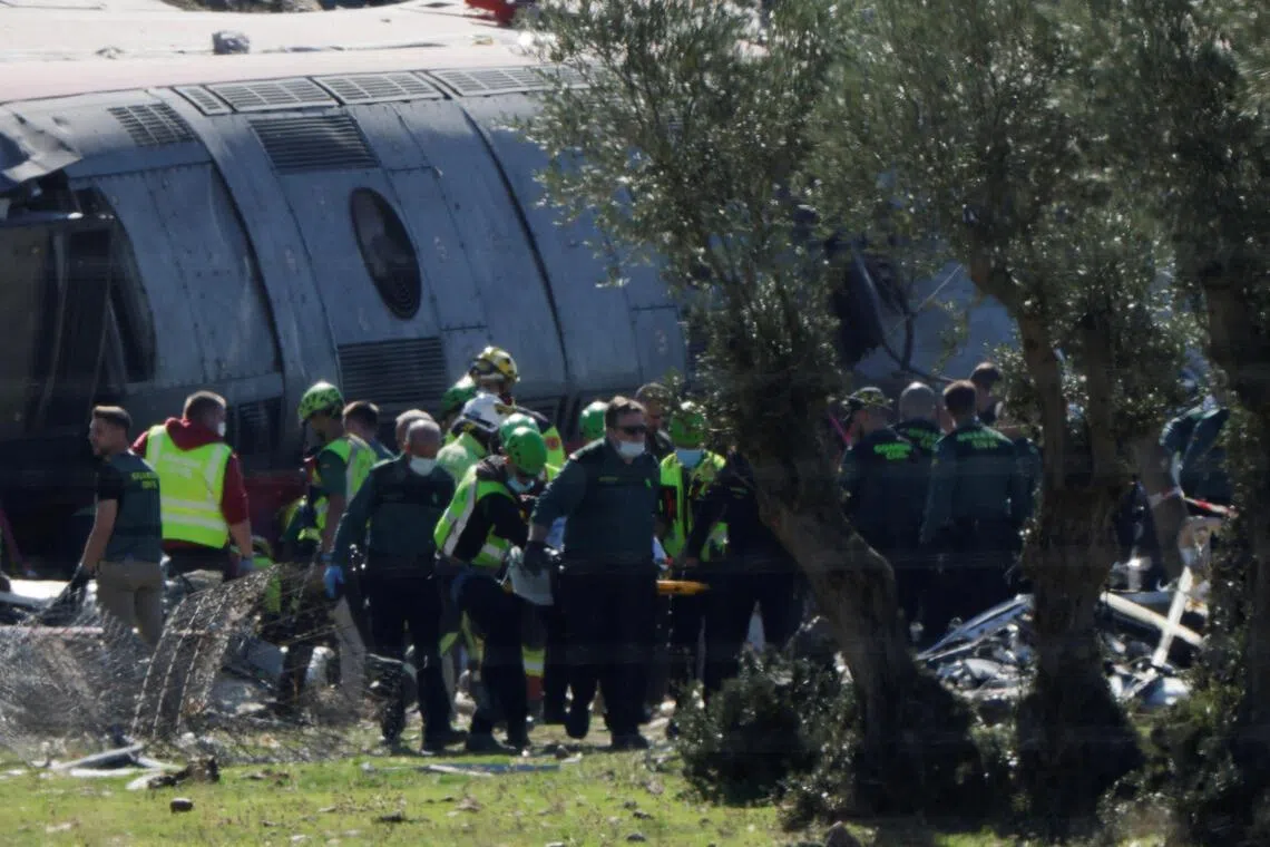 Rescue personnel working to recover bodies following the collision of two high-speed trains between the towns of Mora and Orgaz, near Toledo, Spain, on Oct 28.