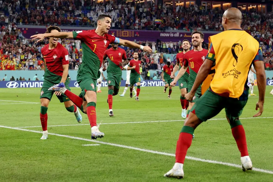 Portugal's Cristiano Ronaldo celebrates scoring their first goal with Joao Felix and Bernardo Silva.