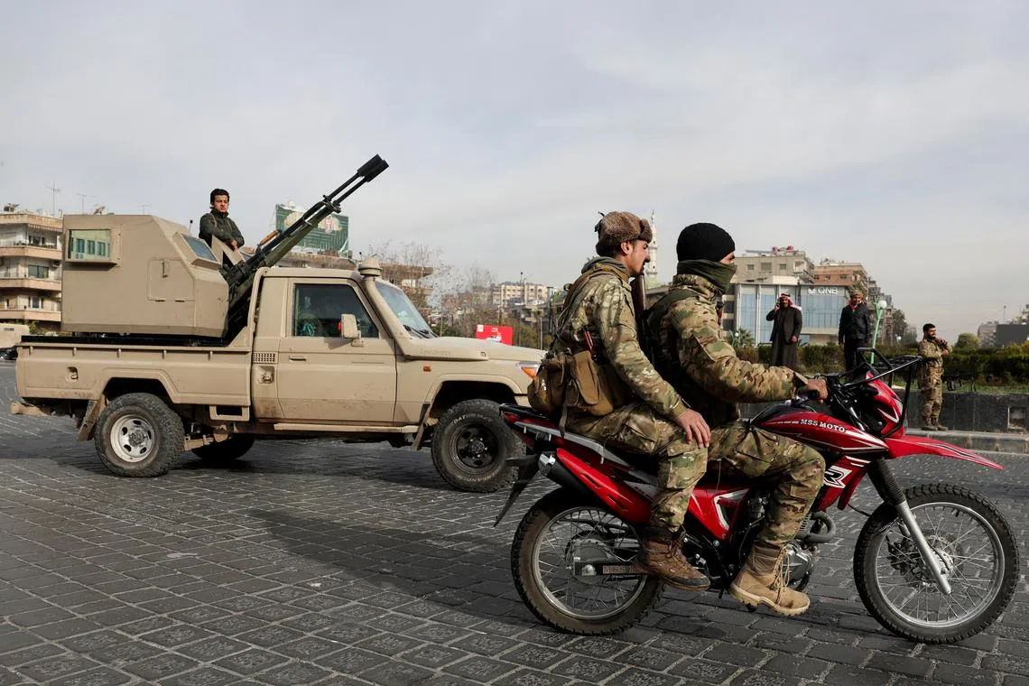 Rebel fighters keep guard at Abbasiyyin Square, after rebels seized the capital and ousted Syria's Bashar al-Assad, in Damascus, Syria December 11, 2024. REUTERS/Amr Abdallah Dalsh