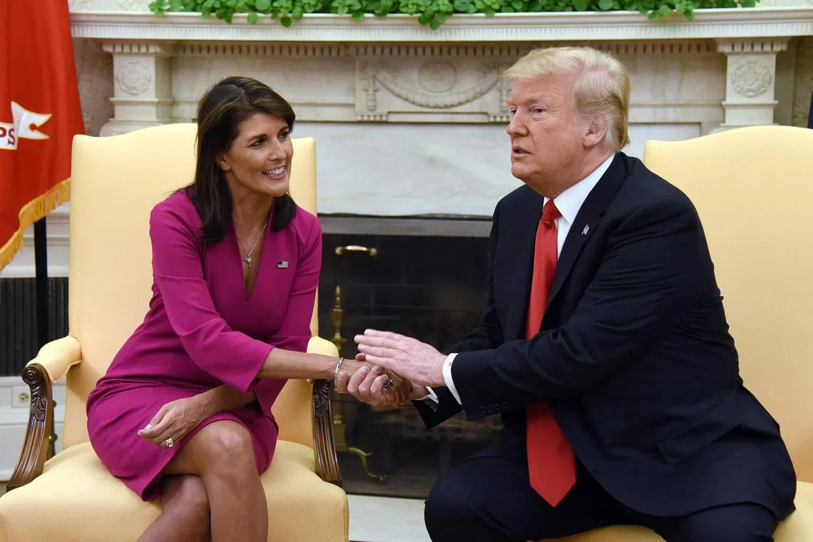 In this file photo taken on October 9, 2018, US President Donald Trump shakes hands with Nikki Haley, the then United States Ambassador to the United Nations, in the Oval office of the White House. They are set to duel at the four-day Conservative Political Action Conference.