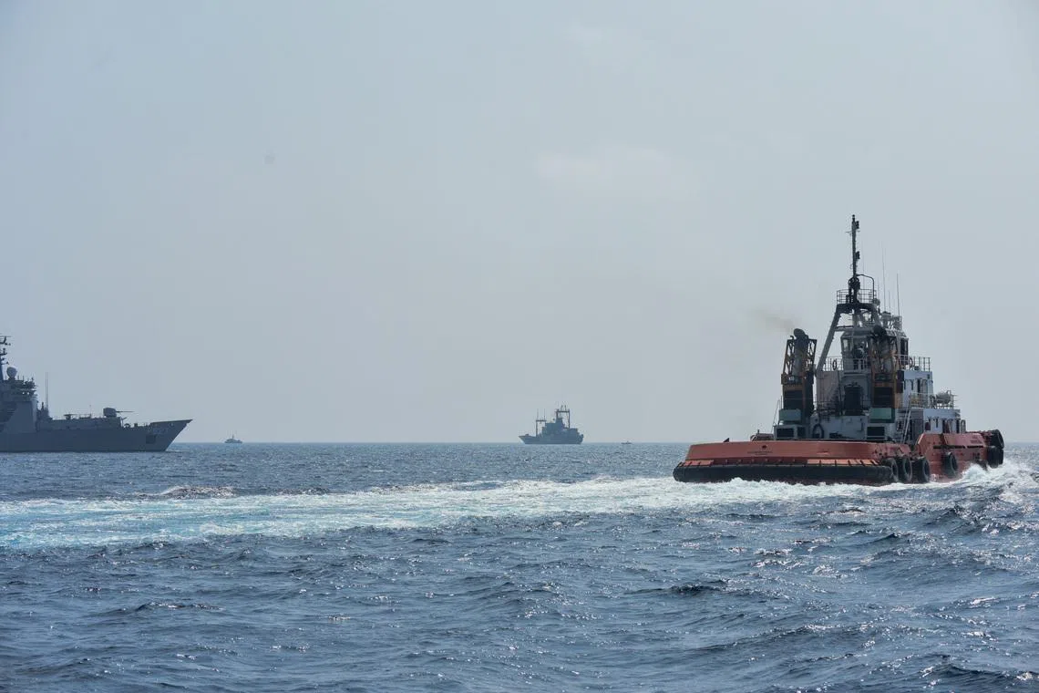 A Sri Lankan Navy tug boat and naval vessels approach an Iranian vessel during a rescue operation, a day after the crew of a distressed Iranian military ship, IRIS Dena were assisted in waters south of Sri Lanka, off the coast of Colombo, Sri Lanka March 5, 2026. Sri Lanka Navy/Handout via REUTERS