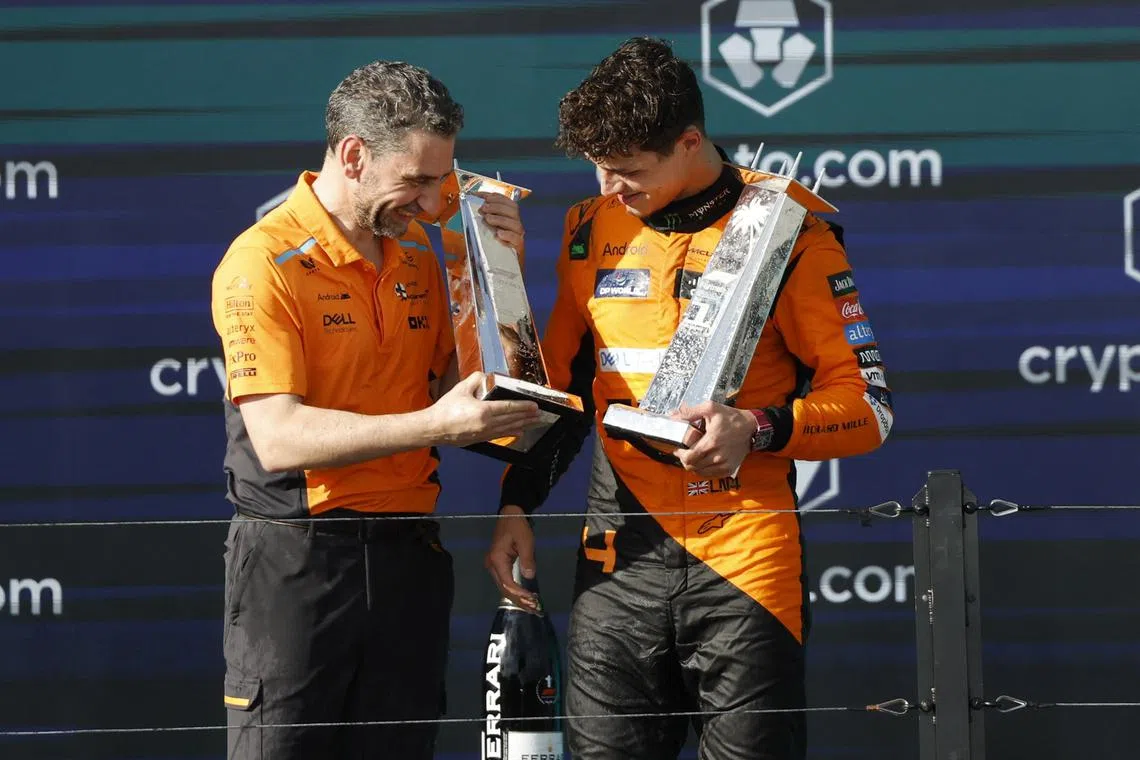 FILE PHOTO: Formula One F1 - Miami Grand Prix - Miami International Autodrome, Miami, Florida, United States - May 5, 2024 McLaren's Lando Norris celebrates winning the Miami Grand Prix on the podium algonside McLaren Team Principal Andrea Stella REUTERS/Marco Bello