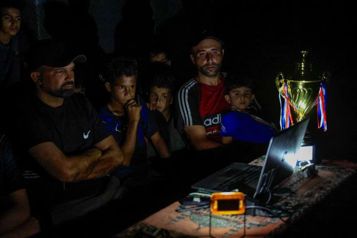 Gazans displaced by war watch World Cup from the ruins