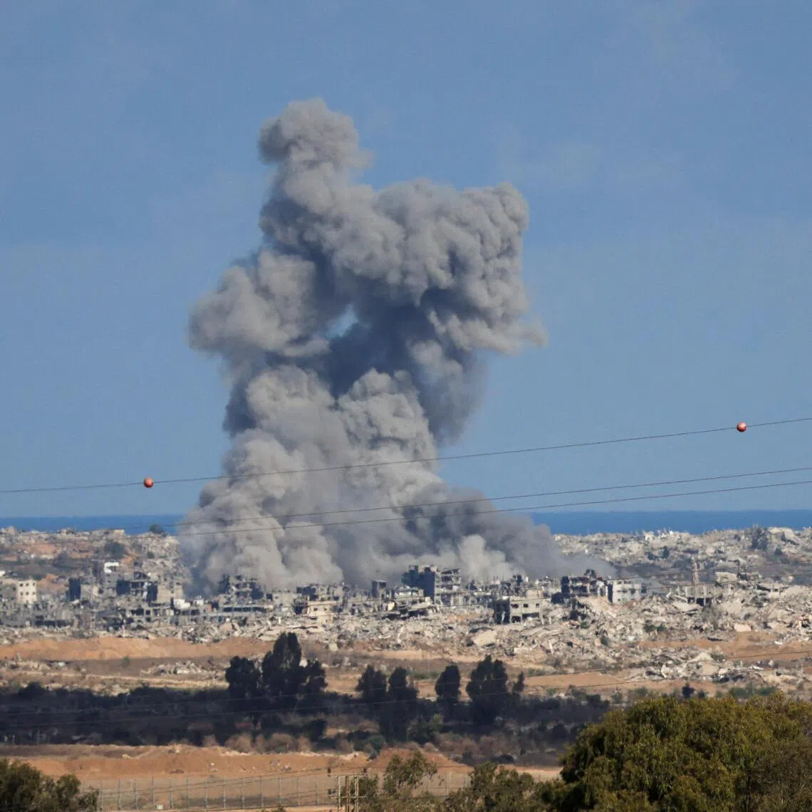Smoke rises from explosions in Gaza, as seen from southern Israel, on Oct 7.