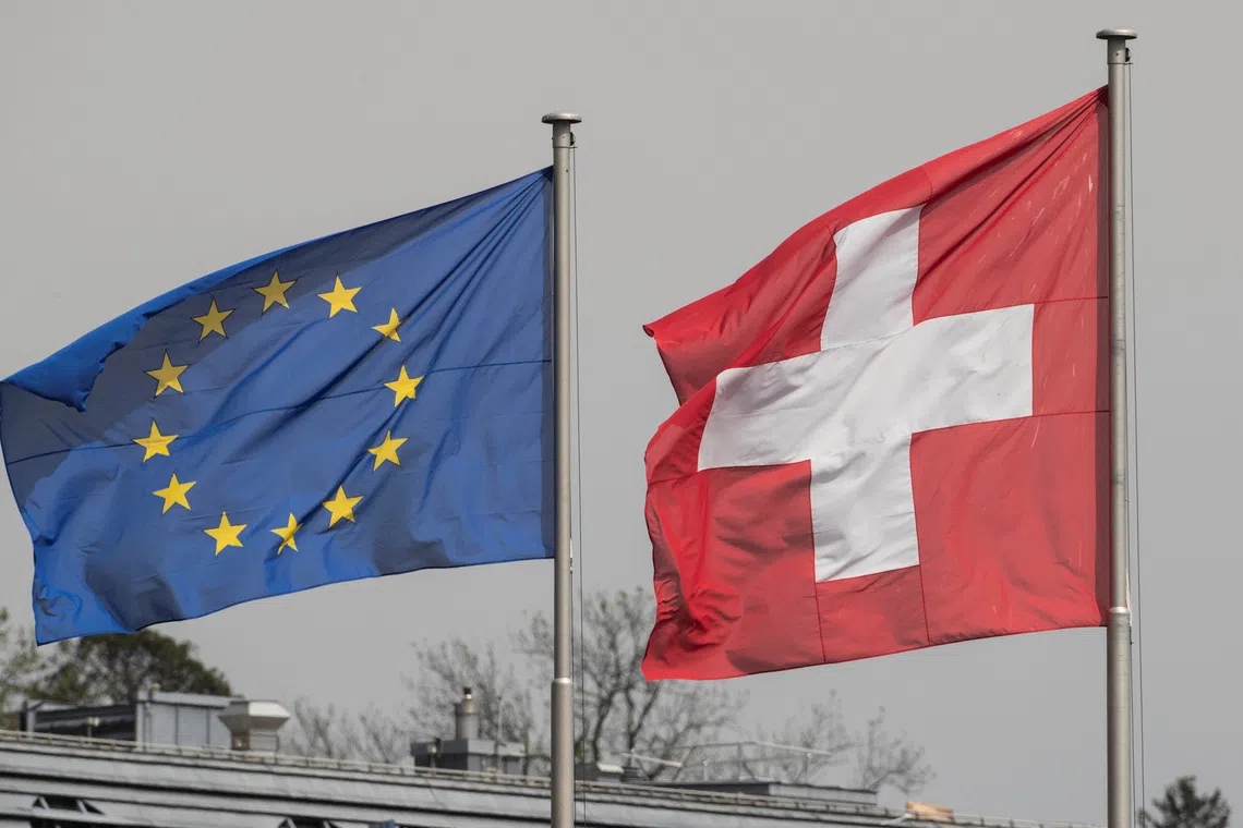 Switzerland's national flag flies beside the one of the European Union in Zurich, Switzerland May 3, 2022.   REUTERS/Arnd Wiegmann