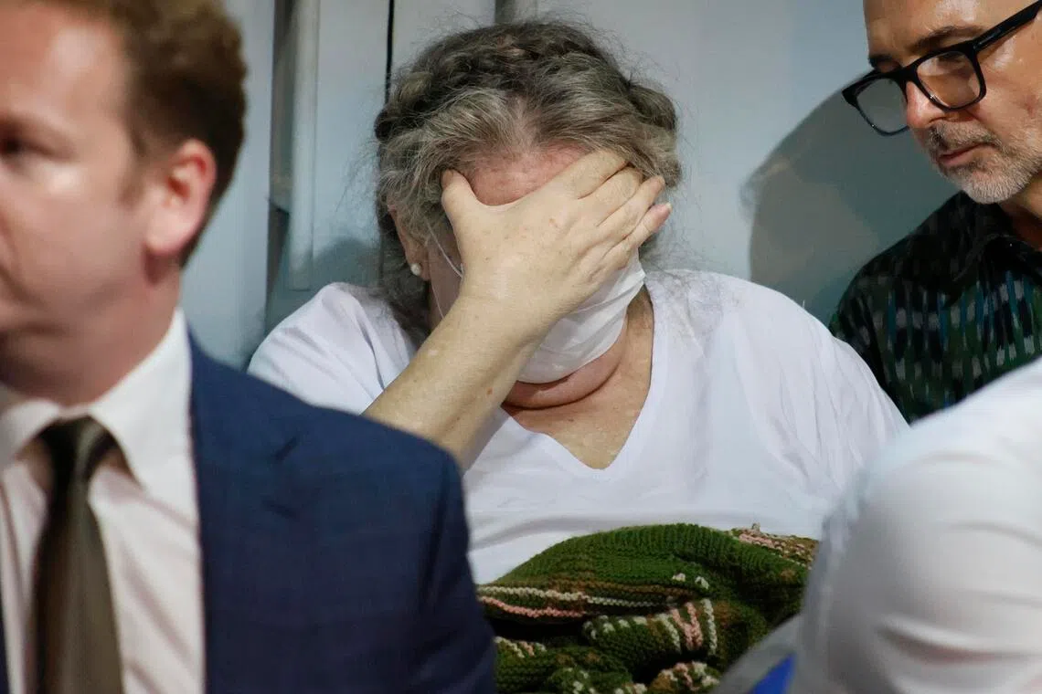 Lindsay Sandiford covering her face during a Nov 6 handover ceremony in Bali for her repatriation.