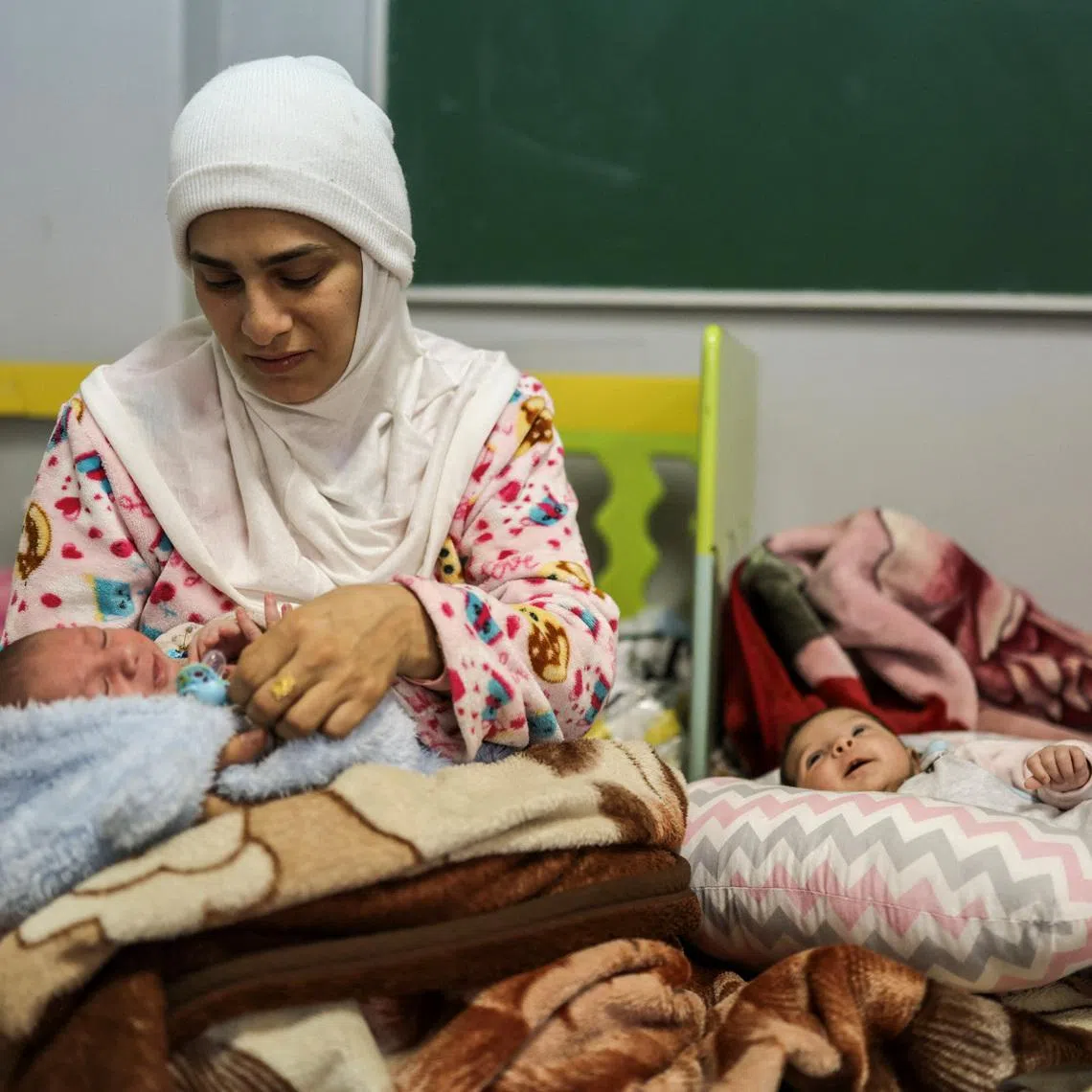 Hawraa Houmani, 29, holds her newborn Ali, in a school now used as a temporary shelter for displaced people, amid escalating hostilities between Israel and Hezbollah, as the U.S.-Israel conflict with Iran continues, in Beirut, Lebanon, March 27, 2026. REUTERS/Emilie Madi
