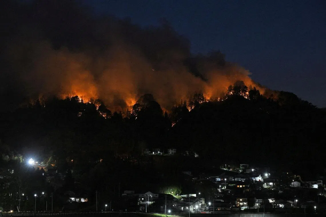 A wildfire burns near the Kirikiri district of Otsuchi, Iwate Prefecture, Japan, on April 24, 2026, as wildfires continue, following their outbreak at two locations in northeastern Japan two days ago, in this photo taken by Kyodo.
