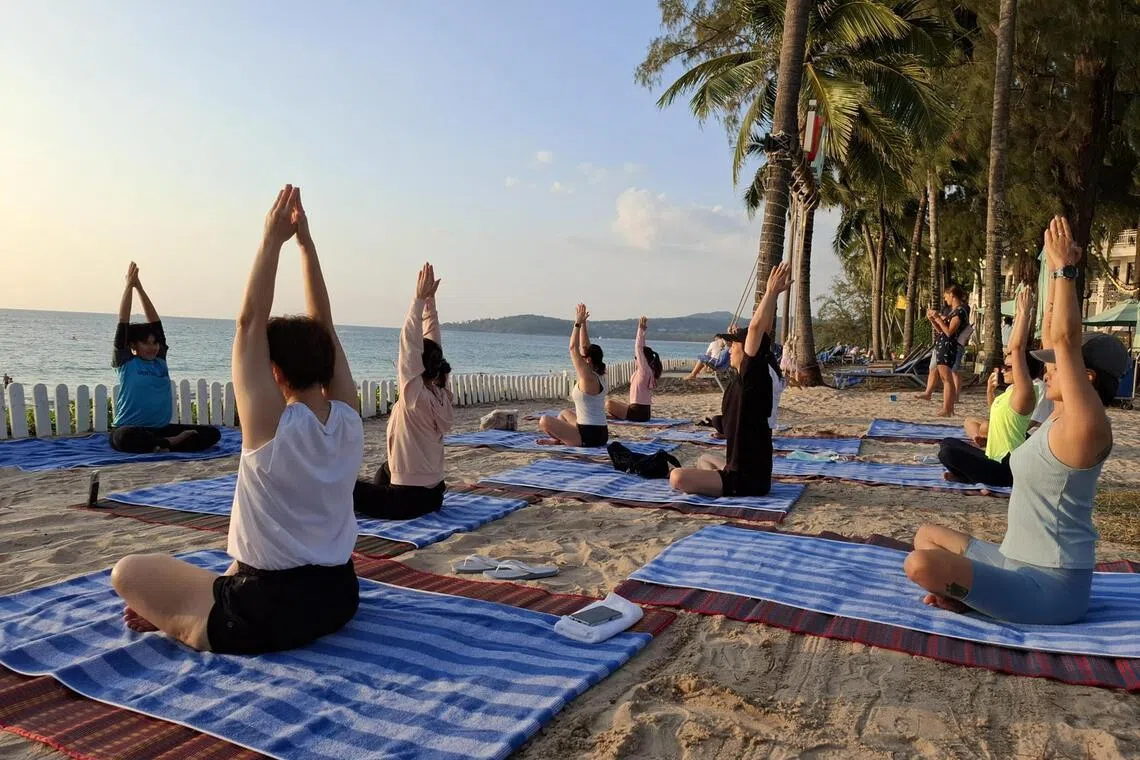 A sunset yoga class is part of the wellness programme at SAii Laguna Phuket. 