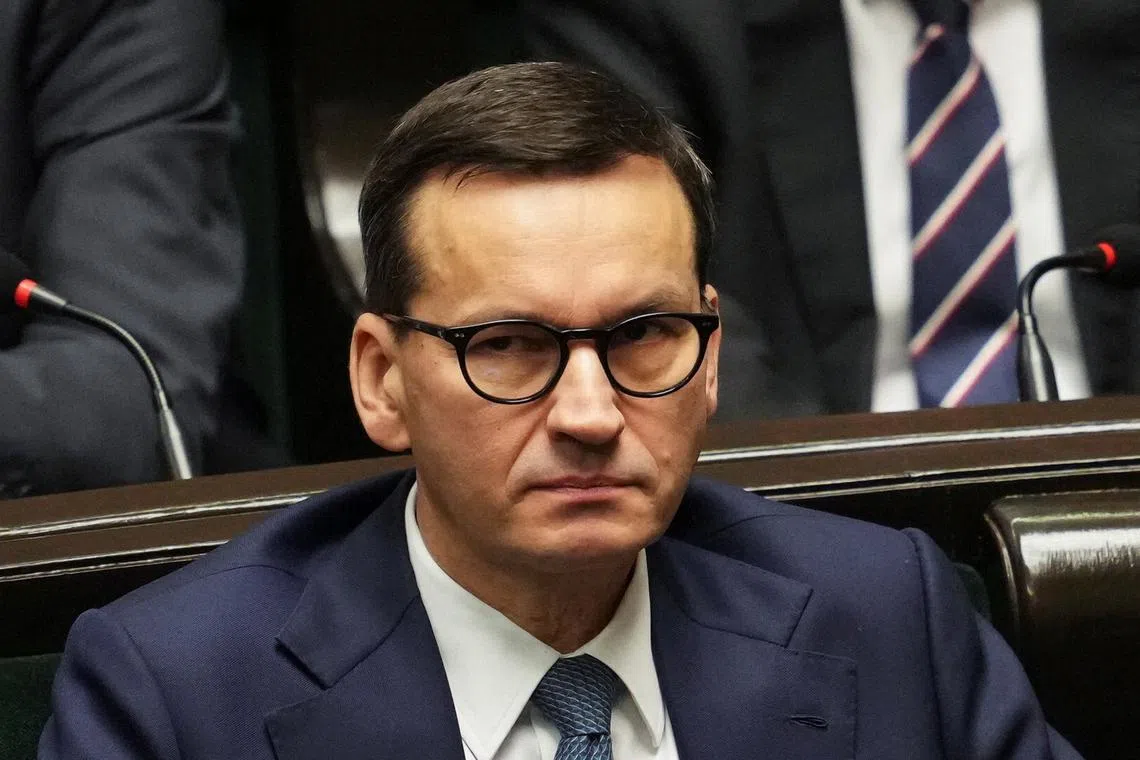 FILE PHOTO: Former Polish Prime Minister Mateusz Morawiecki looks on as Prime Minister Donald Tusk (not pictured) presents his government's programme and asks for a vote of confidence in Parliament in Warsaw, Poland December 12, 2023. REUTERS/Aleksandra Szmigiel/File Photo