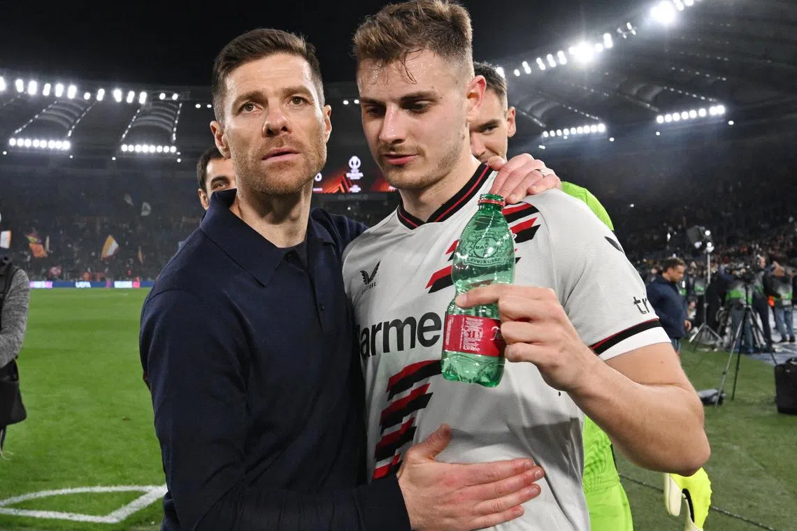 Bayer Leverkusen coach Xabi Alonso and Josip Stanisic celebrate after the 2-0 Europa League semi-final, first-leg win over Roma.