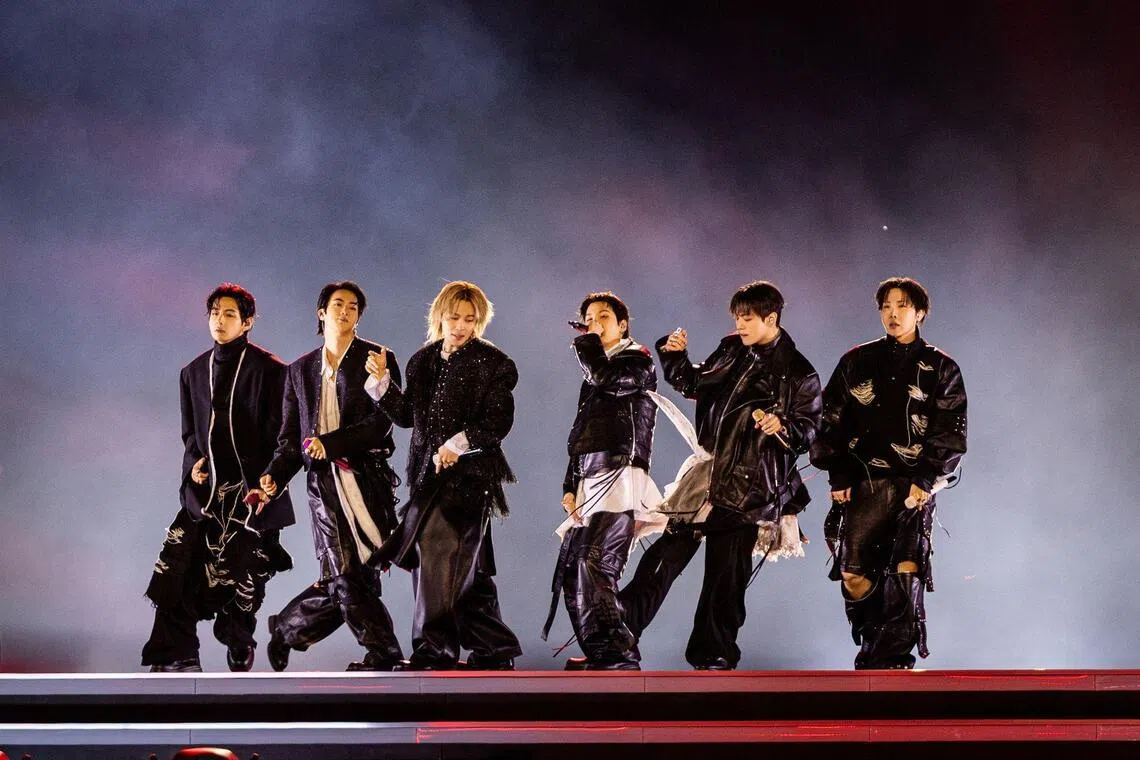 This handout photo taken on March 21, 2026 and provided by BIGHIT MUSIC and NETFLIX shows K-pop boy group BTS performing during the BTS comeback concert at Gwanghwamun Square in Seoul. South Korean megastars BTS performed their first show in nearly four years on March 21, in front of enormous crowds in Seoul for a K-pop extravaganza livestreamed to millions more worldwide. (Photo by Handout / BIGHIT MUSIC and NETFLIX / AFP) / RESTRICTED TO EDITORIAL USE - MANDATORY CREDIT "AFP PHOTO / BIGHIT MUSIC and NETFLIX" - NO MARKETING NO ADVERTISING CAMPAIGNS - DISTRIBUTED AS A SERVICE TO CLIENTS