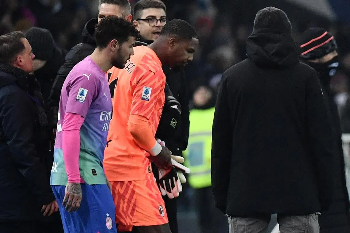 AC Milan goalkeeper Mike Maignan walking back onto the pitch after the match on Jan 20 against Udinese was stopped after he was racially abused by fans.