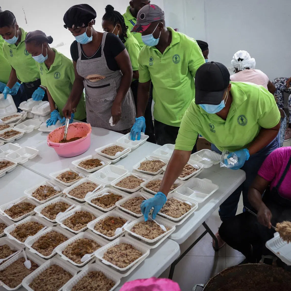 A community action center, with the assistance of the United Nations World Food Programme, prepare hot meals for gang war refugees at Jeunes Filles high school in Port-au-Prince, Haiti, May 3, 2024.  REUTERS/Ricardo Arduengo/File Photo