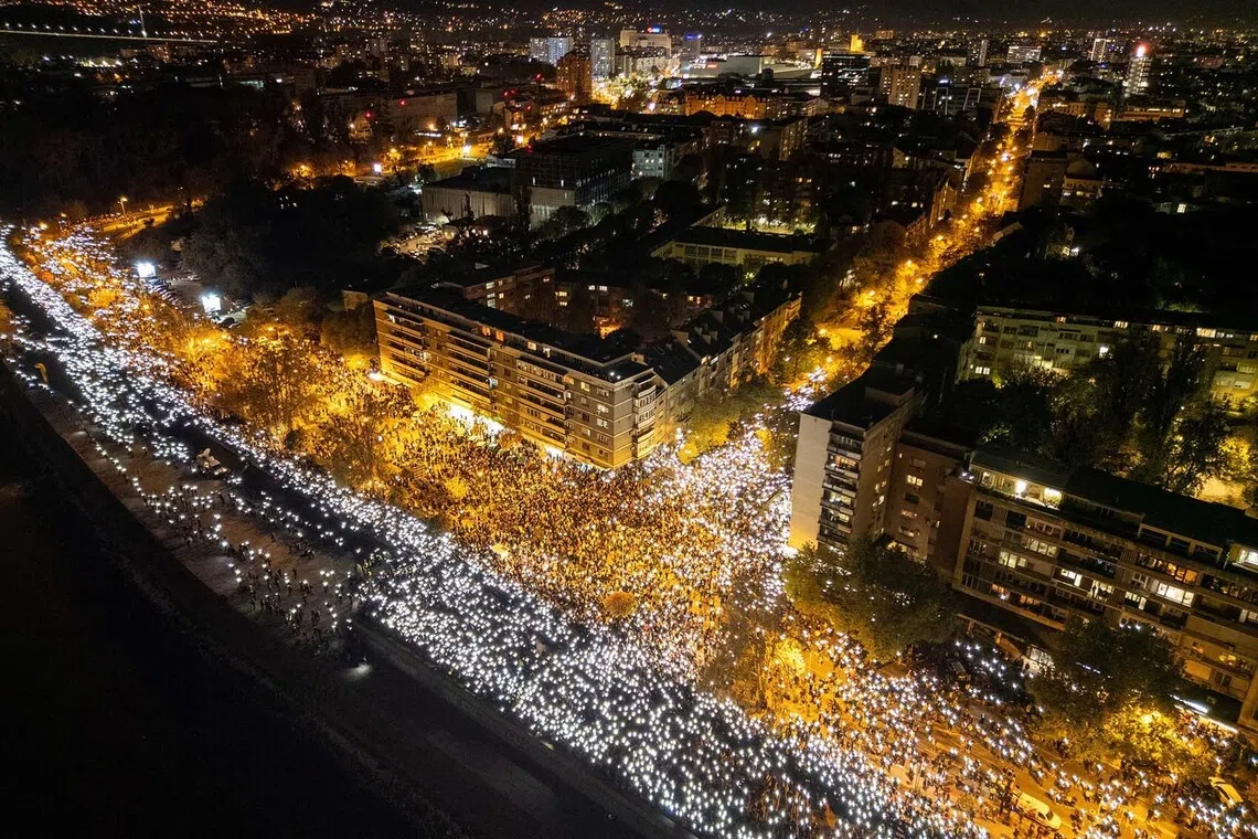 People flashing mobile phone lights during a 16 minutes of silence, on the first anniversary of the fatal November 2024 Novi Sad railway station canopy collapse which killed 16 people, triggering nationwide accusations of widespread corruption and negligence, in Novi Sad, Serbia, Nov 1, 2025. 