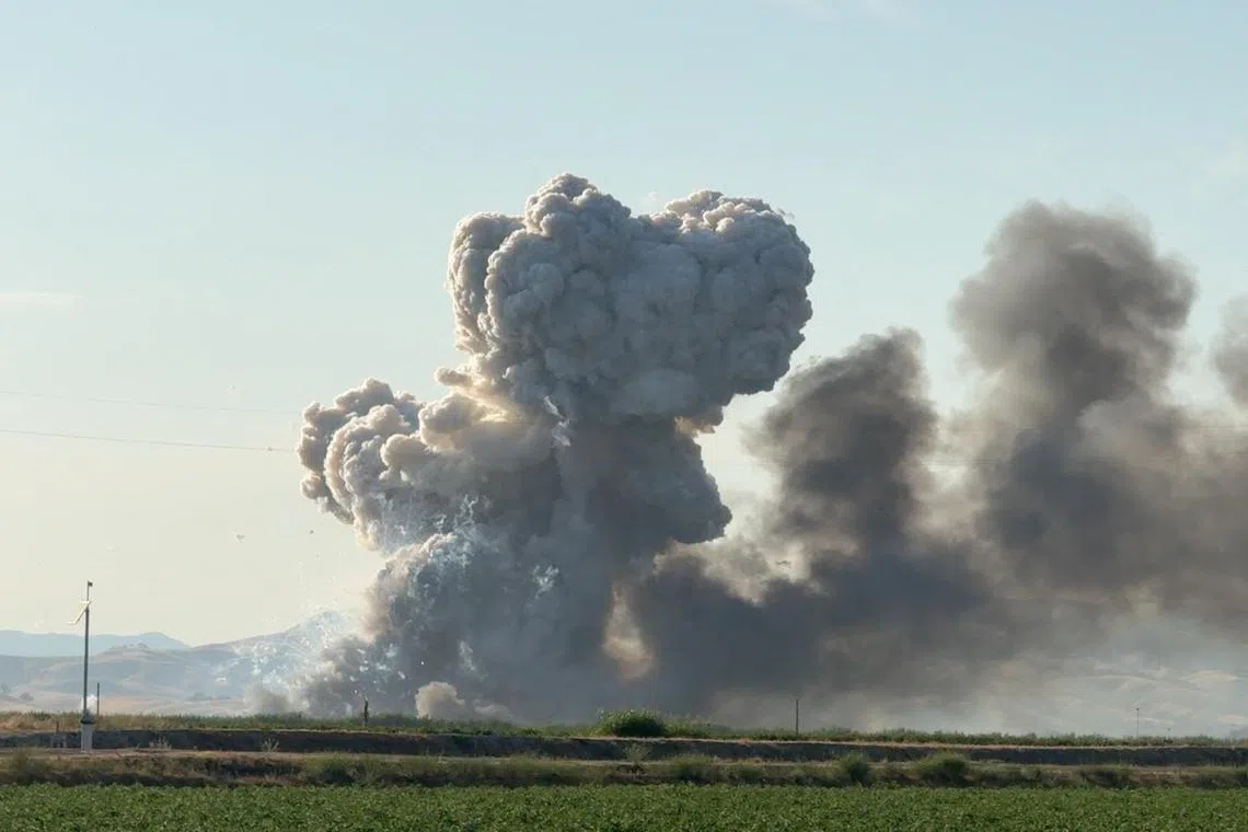 Clouds of smoke rise following explosions on July 1 at a fireworks storage warehouse in Esparto, California.