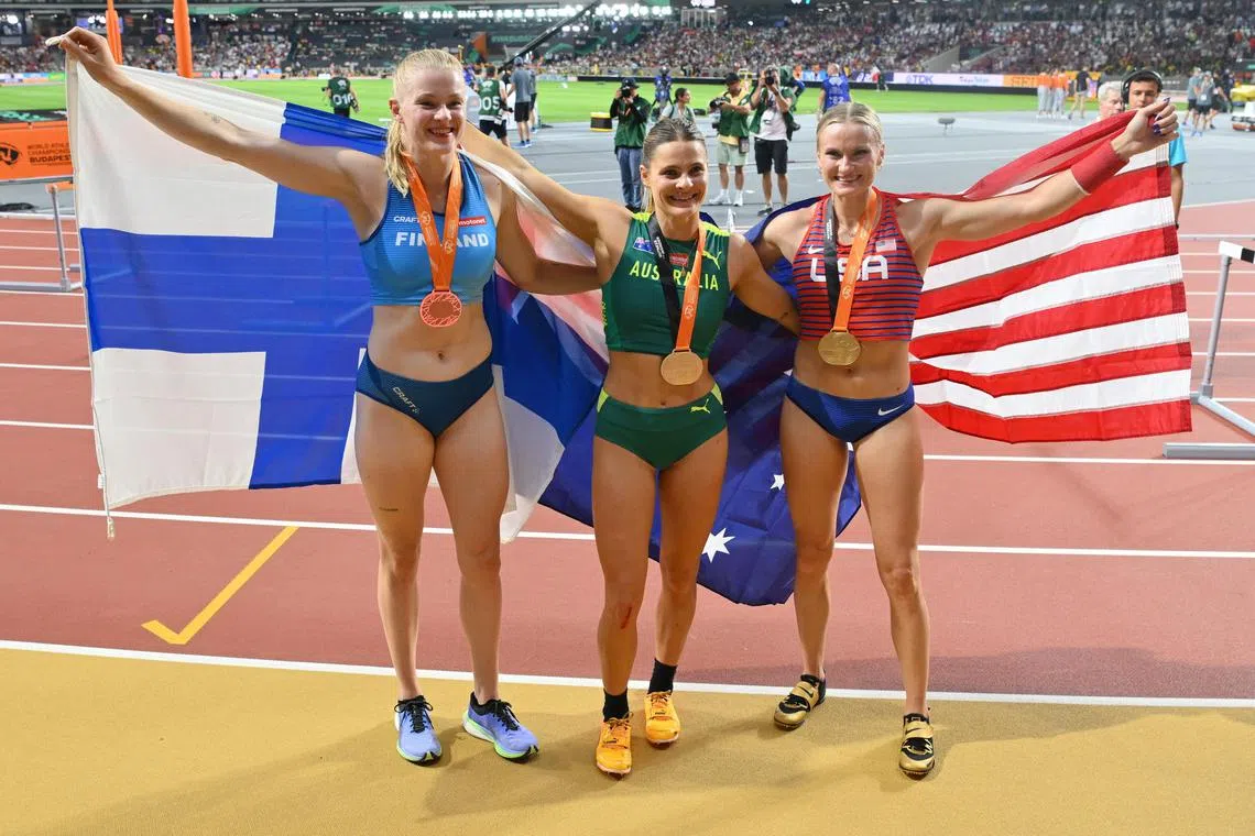 Gold medalists Nina Kennedy of Australia (centre) and Katie Moon of the US (right), celebrate with Finland's bronze medal winner Wilma Murto.