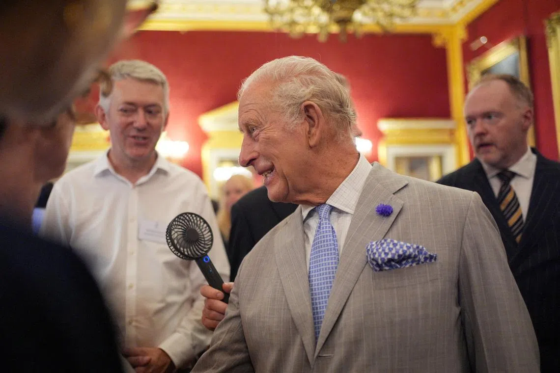 Britain’s King Charles III had to be cooled with a portable fan as he attended a reception in London on June 24.