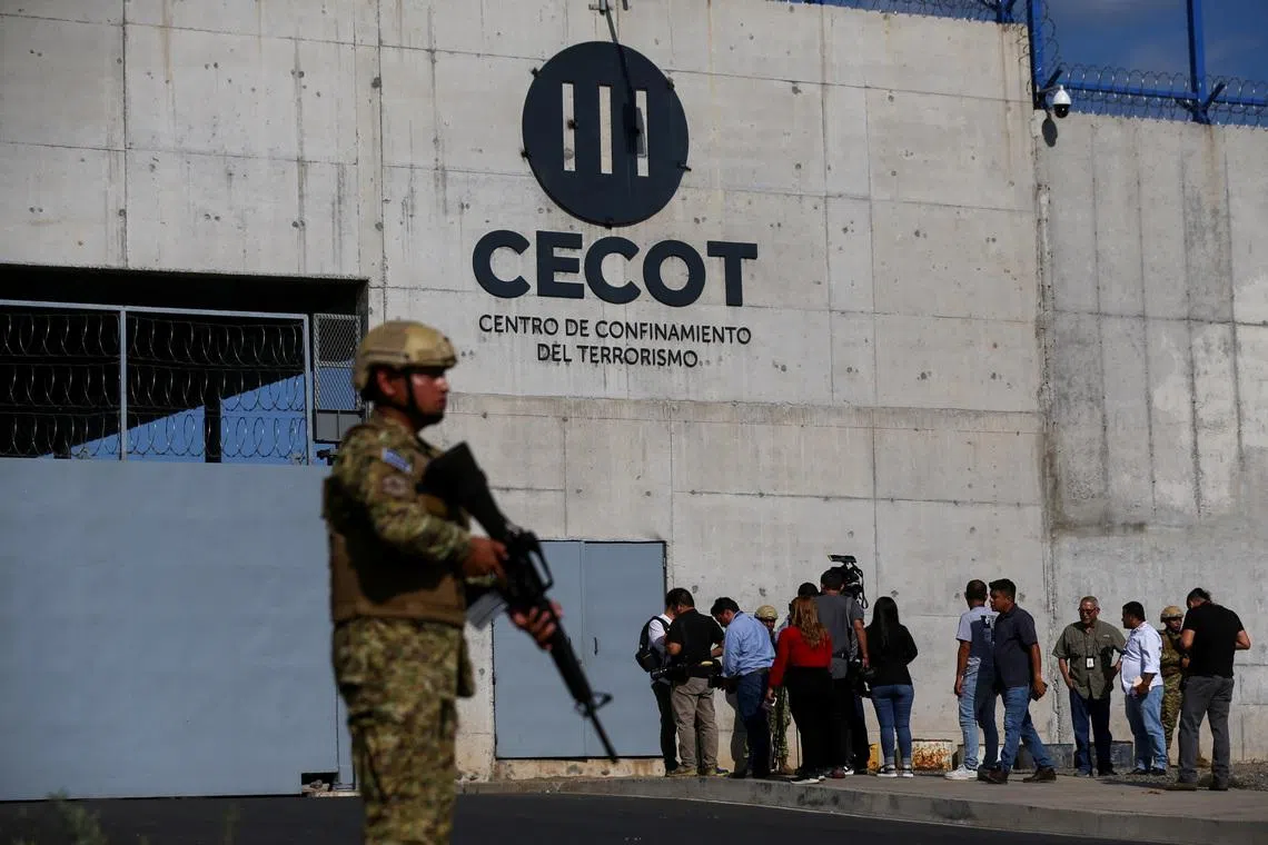 A Salvadoran soldier stands guard, as the CECOT logo is seen, during a media tour at the Terrorism Confinement Center (CECOT) prison, in Tecoluca, El Salvador April 4, 2025. REUTERS/Jose Cabezas