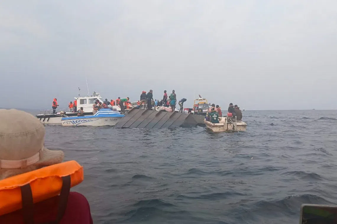 Rescue workers and local boat operators take part in ongoing search and recovery operations near the overturned passenger ferry on Lake Kariba, a day after the vessel capsized, in Kariba, Zimbabwe, August 12, 2026. REUTERS/Admore Mbonda