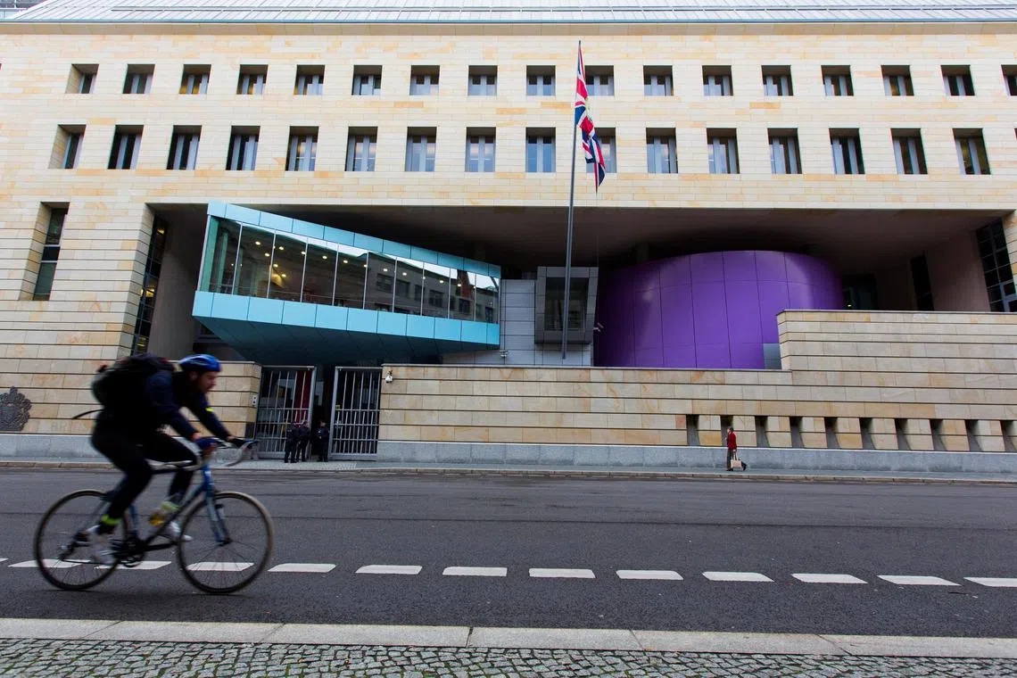 FILE PHOTO: A man cycles past the British Embassy in Berlin November 5, 2013.   REUTERS/Thomas Peter/File Photo