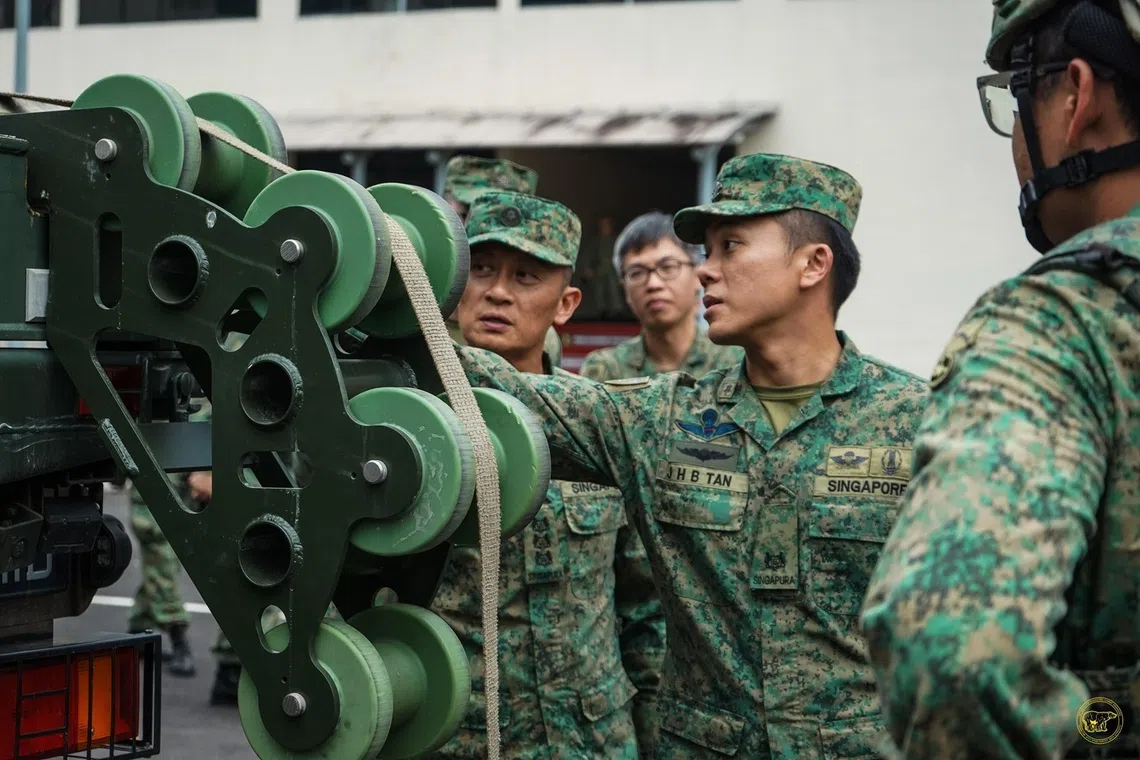 brandon tan conducting an equipment inspection with personnel from 30th battalion, singapore combat engineers