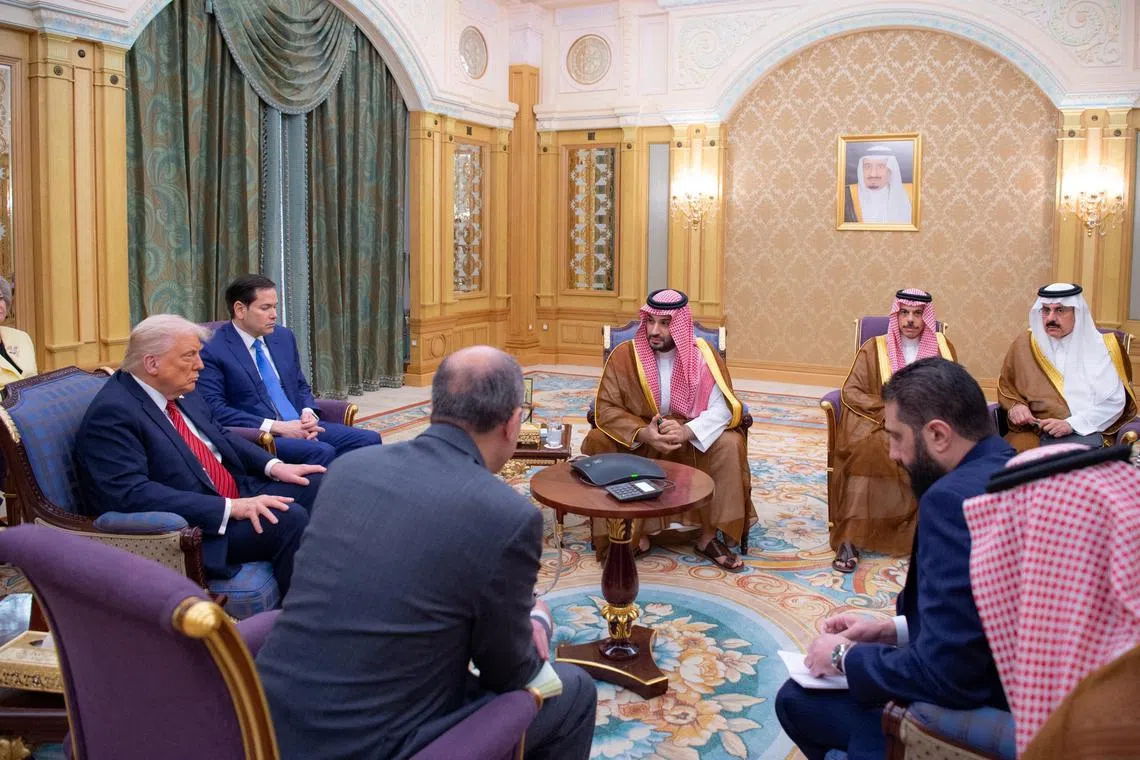 FILE PHOTO: Syrian President Ahmed al-Sharaa meets with U.S. President Donald Trump and Saudi Crown Prince Mohammed Bin Salman and other officials in Riyadh, Saudi Arabia, in this handout released on May 14, 2025. Saudi Press Agency/Handout via REUTERS/File Photo