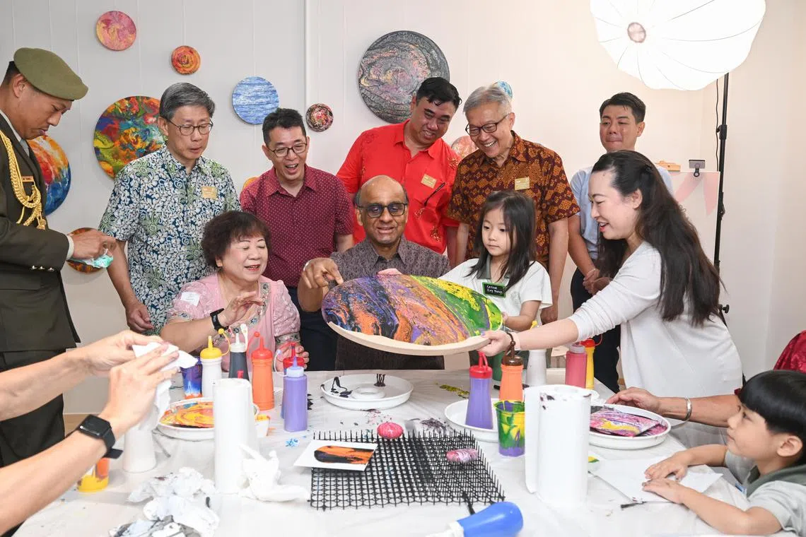 President Tharman Shanmugaratnam participating in an acrylic art pouring session at A Good Place at One Holland Village on Feb 11.