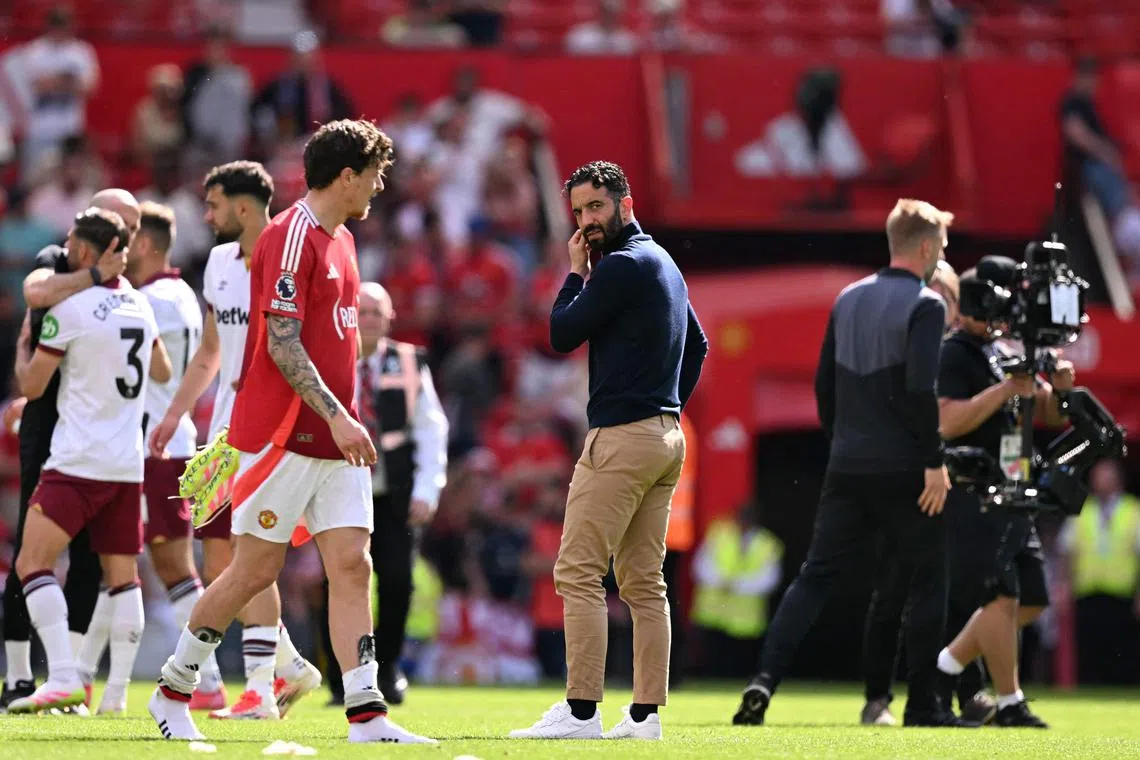 Manchester United's Portuguese head coach Ruben Amorim (C) on the pitch after the English Premier League football match between Manchester United and West Ham United at Old Trafford in Manchester, north west England, on May 11, 2025. West Ham won the game 2-0. (Photo by Oli SCARFF / AFP) / RESTRICTED TO EDITORIAL USE. No use with unauthorized audio, video, data, fixture lists, club/league logos or 'live' services. Online in-match use limited to 120 images. An additional 40 images may be used in extra time. No video emulation. Social media in-match use limited to 120 images. An additional 40 images may be used in extra time. No use in betting publications, games or single club/league/player publications. / 